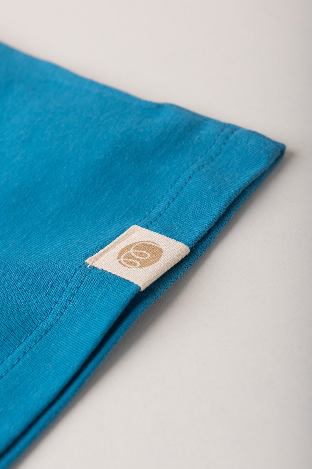 Conjunto Menina Blusa Box Manga Curta Azul Turquesa e Saia com Shorts Off Natural