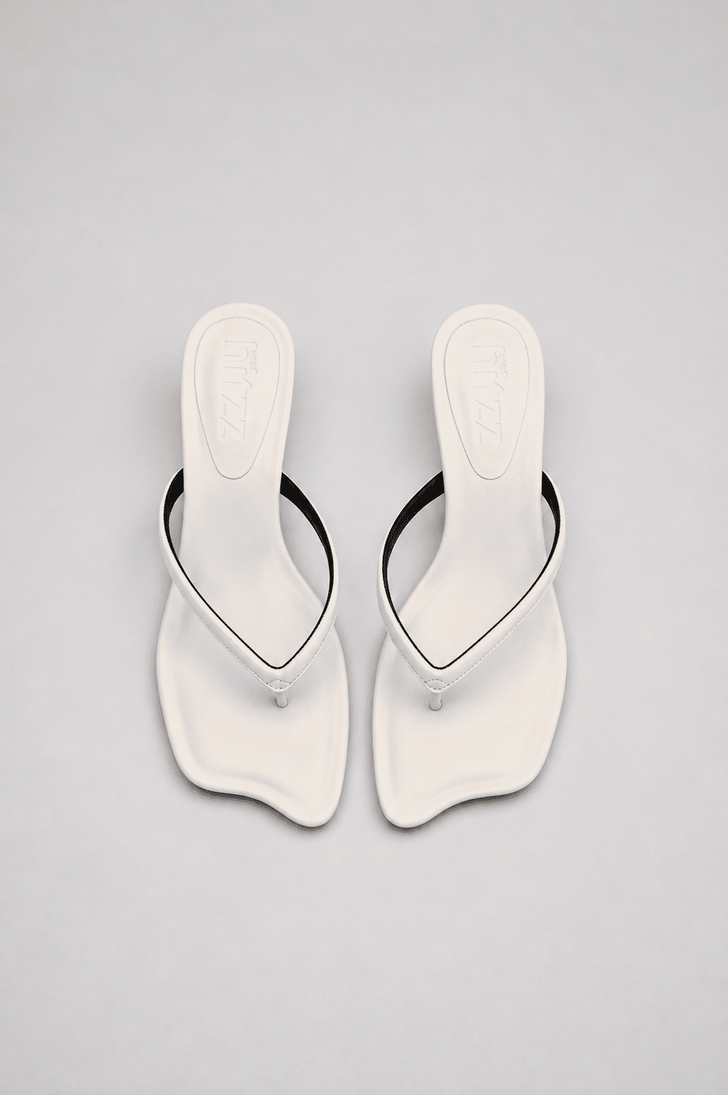 hanna-tamanco-feminino-off-white Tamanco Feminino Couro Dedo Salto Hanna off white, vista do par, com tiras finas de dedo, salto baixo curvado e bico irregular