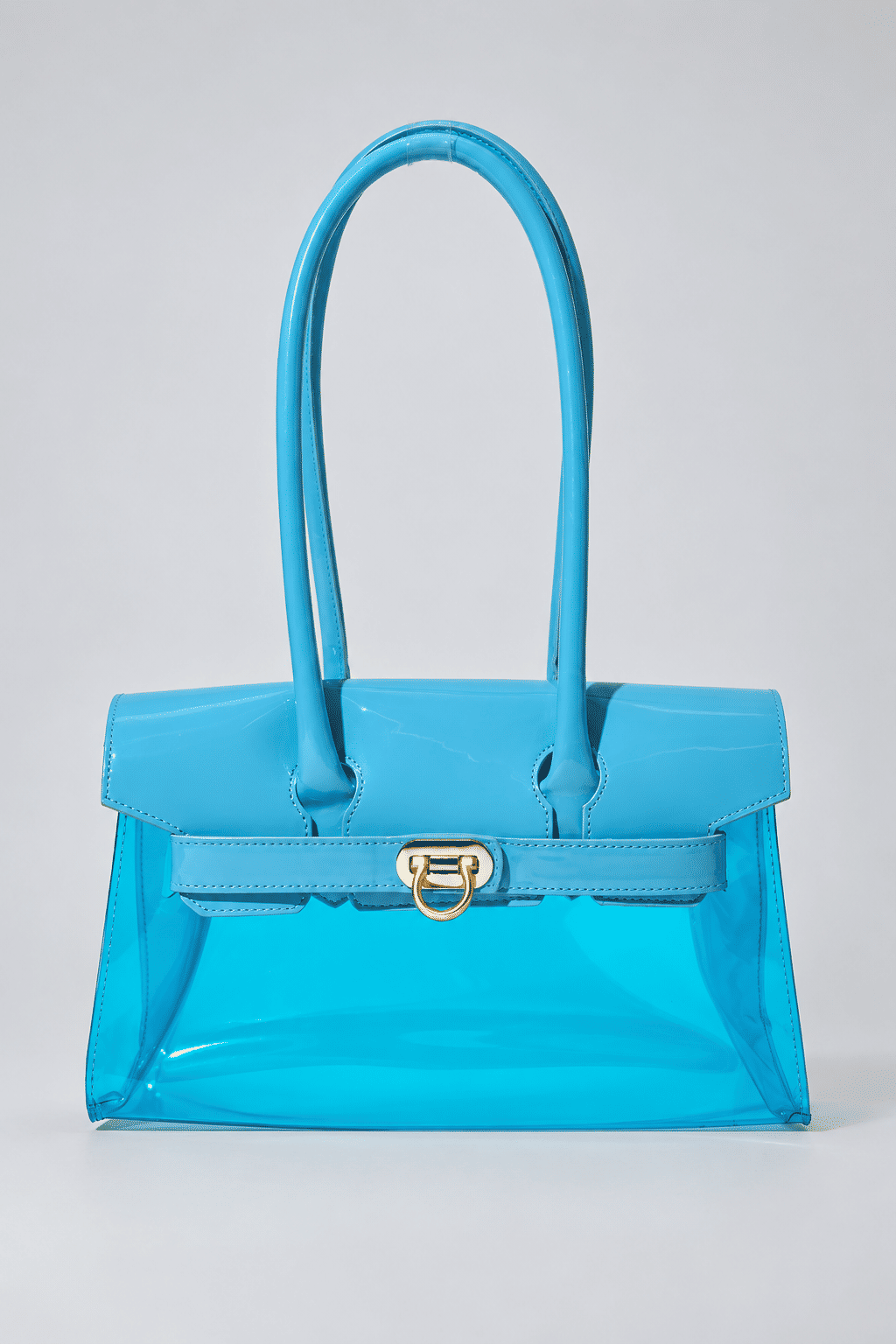 gummy-bolsa-feminina-transparente-verniz-azul-claro Bolsa Feminina Transparente Verniz Gummy azul claro com alças longas e fecho metálico dourado frontal.