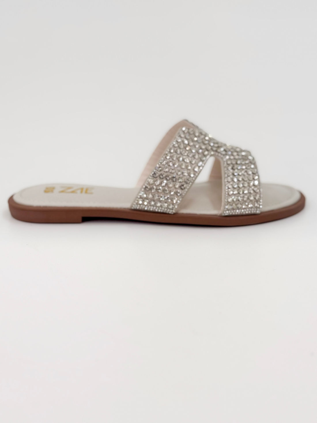 Clarice — Chinelo Rasteira Off White com Tiras Prateadas Clarice — Chinelo Rasteira Off White com Tiras Prateadas