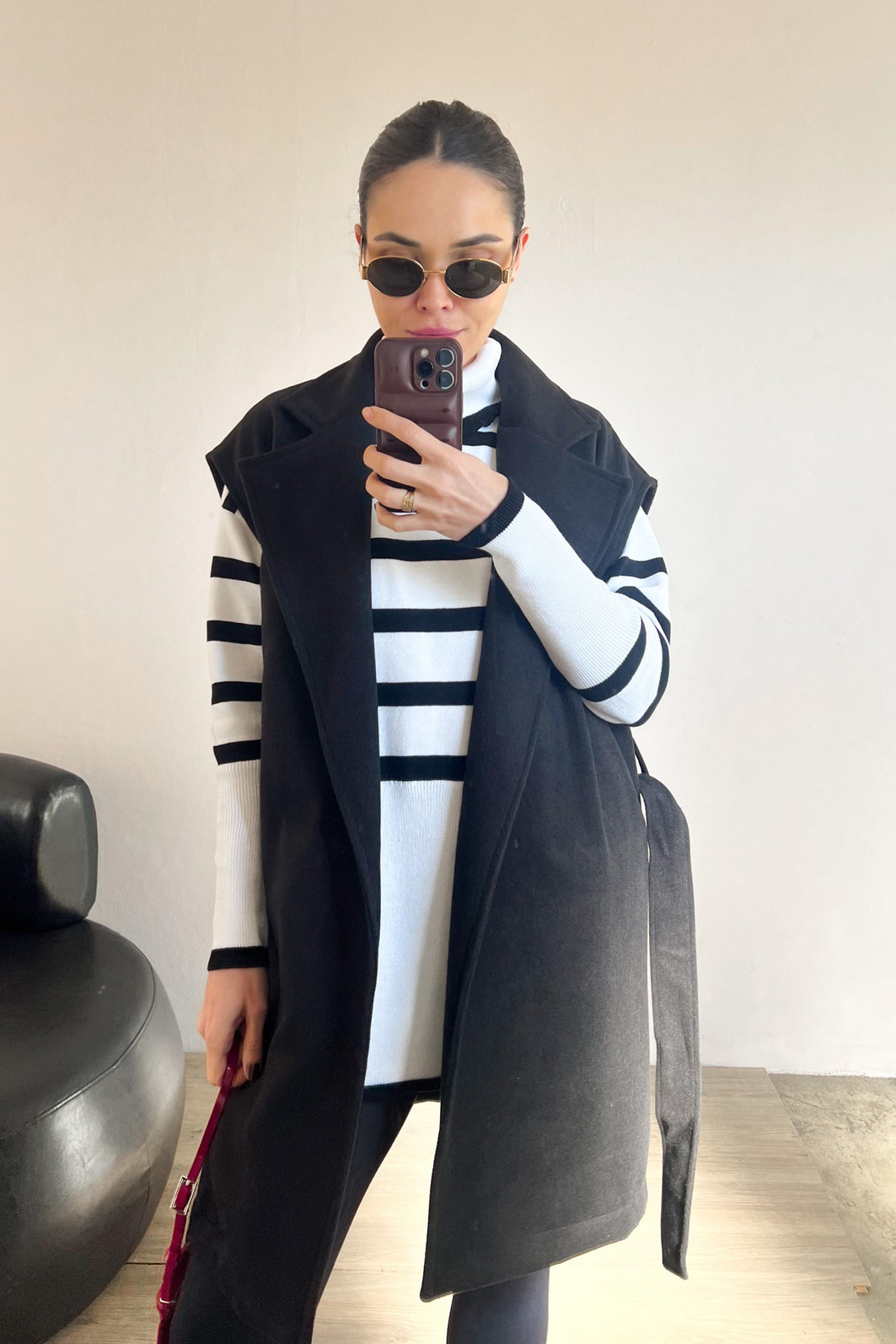 Modelo usando blusão branco com listras pretas  de gola e manga comprida