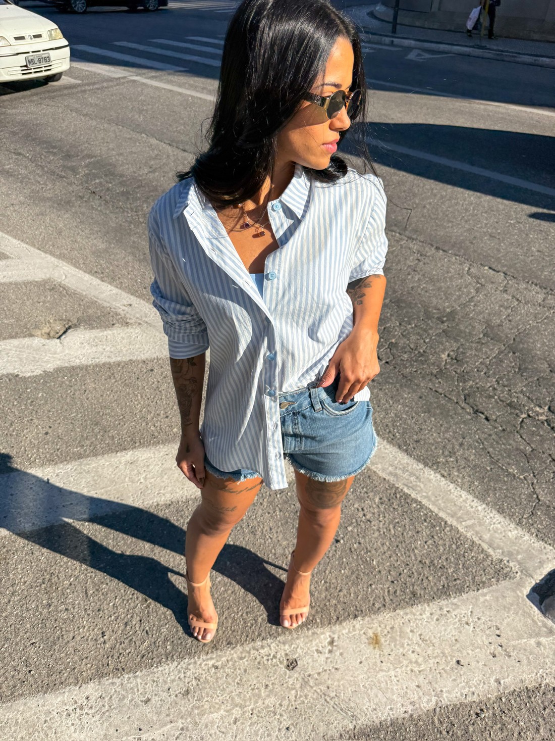 camisa listrada azul, camisa feminina manga longa, camisa oversized, camisa com botões, look street feminino, short jeans desfiado, moda verão feminina, outfit casual, estilo despojado, roupas femininas modernas