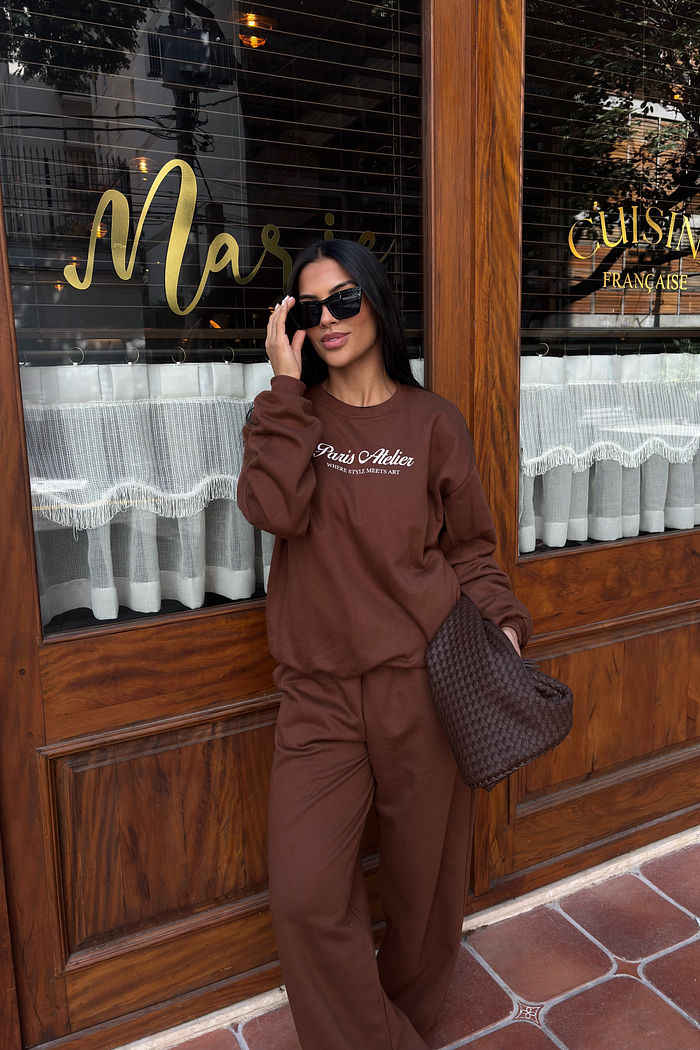 Moletom feminino marrom oversized com estampa frontal Paris Atelier em off white, modelagem ampla e conjunto com calça em look casual confortável