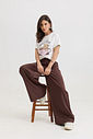 calça pantalona feminina em alfaiataria com cintura alta e elástico nas costas, caimento fluido que não marca o corpo, modelagem ampla com pernas soltas e bolsos laterais funcionais